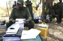 South Sudan's rebel leader Riek Machar sits in the bush in a rebel-controlled territory in Jonglei State