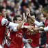 Arsenal's Santi Cazorla celebrates with team mates after scoring against Tottenham Hotspur during their English Premier League soccer match in London