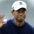 U.S. golfer Tiger Woods holds up his ball after making birdie to end his round 11-under par during second round play at the Farmers Insurance Open in San Diego