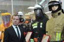 Russian Prime Minister Dmitry Medvedev, front left, visits an exhibition of rescue equipment in Krasnogorsk, outside Moscow, Wednesday, Jan. 30, 2013. (AP Photo/RIA Novosti, Alexander Astafyev, Government Press Service)