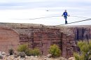 Aerialist Nik Wallenda near the end of his quarter mile walk over the Little Colorado River Gorge in northeastern Arizona on Sunday, June 23, 2013. The daredevil successfully traversed the tightrope strung 1,500 feet above the chasm near the Grand Canyon in just more than 22 minutes, pausing and crouching twice as winds whipped around him and the cable swayed. (AP Photos/Discovery Channel, Tiffany Brown)
