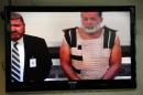 FILE - In this Monday, Nov. 30, 2015, file photo, Colorado Springs shooting suspect, Robert Dear, right, appears via video before Judge Gilbert Martinez, with public defender Dan King, left, at the El Paso County Criminal Justice Center for this first court appearance, where he was told he faces first degree murder charges in Colorado Springs, Colo. The man accused of killing multiple people at a Planned Parenthood clinic in Colorado asked at least one person in a nearby shopping center for directions to the facility before opening fire, a law enforcement official said. (Daniel Owen/The Gazette via AP, Pool)