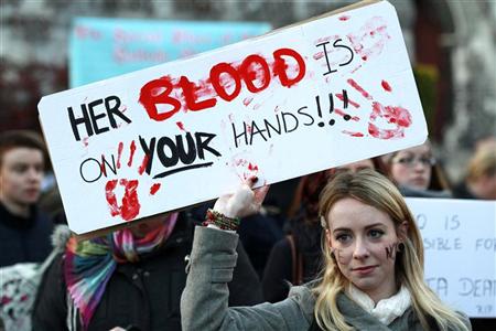 A woman holds a poster during a vigil in Dublin November 17, 2012, in memory of Savita Halappanavar and in support of changes to abortion law. REUTERS/Cathal McNaughton