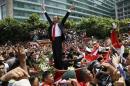 Indonesian President Joko Widodo gestures to the crowd during a street parade following his inauguration in Jakarta, Indonesia, Monday, Oct. 20, 2014. (AP Photo/Achmad Ibraham)