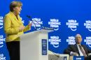 German Chancellor Angela Merkel, left, speaks next to German Klaus Schwab, right, founder and president of the World Economic Forum, WEF, during a panel session of the 45th annual meeting of the World Economic Forum, WEF, in Davos, Switzerland, Thursday, Jan. 22, 2015. The meeting runs from Jan. 21 through Jan. 24. (AP Photo/Keystone, Laurent Gillieron)