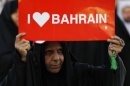A protester holds a banner saying "I Love Bahrain" as she participates in a rally organised by Bahrain's main oppostion society Al Wefaq, in Budaiya