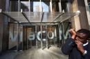 A security guard speaks into a microphone in his sleeve outside the Viacom Inc. headquarters in New York