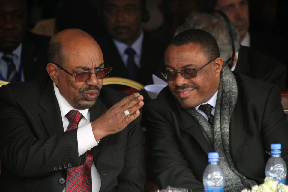 Ethiopian prime minister Hailemariam Dessalegni and Sudan's President Omar al-Bashir chat during the the first year anniversary ceremonyof the death of long-time ruler Meles Zenawi in Addis Ababa, Ethiopia, Tuesday Aug. 20, 2013. The ceremony attended by regional leaders including presidents of Somalia and Sudan, Meles was praised as “Africa’s voice.” His successor Prime Minister Prime Minister Hailemariam Desalegn praised Meles as a “champion of the poor.” (AP Photo/Elias Asmare)