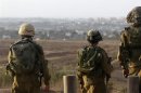 Israeli soldiers patrol near the border with the Gaza Strip