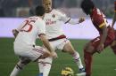 Roma's Gervinho, right, and AC Milan's Keisuke Honda fight for the ball during their Serie A soccer match between Roma and AC Milan at Rome's Olympic stadium, Saturday, Dec. 20, 2014. (AP Photo/Gregorio Borgia)