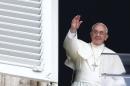 Pope Francis waves as he leads his Sunday Angelus prayer in Saint Peter's square at the Vatican