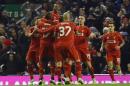 Liverpool's Raheem Sterling, top, celebrates his goal with teammates during the English League Cup semi-final first leg soccer match between Liverpool and Chelsea at Anfield Stadium, Liverpool, England, Tuesday Jan. 20, 2015. (AP Photo/Jon Super)
