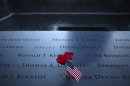 Roses and a U.S. flag are laid amid the names of the First Responders along the South Pool of the 9/11 Memorial in New York