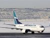 A WestJet Airlines Boeing 737-700 aircraft lands at Calgary International Airport in Alberta