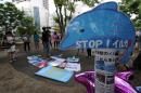 A placard reading 'Stop! Dolphin hunt' is displayed during a protest in central Tokyo on August 31, 2014 against an annual dolphin hunt in Taiji