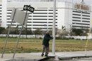 A man holds on to a lamppost as he braces himself against winds in the aftermath of Hurricane Sandy's landfall in Atlantic City
