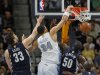 Denver Nuggets forward JaVale McGee (34) dunks for a basket past Memphis Grizzlies center Marc Gasol (33), of Spain, and forwards Zach Randolph (50) and Quincy Pondexter in the first quarter of an NBA basketball game in Denver, Friday, March 15, 2013. (AP Photo/David Zalubowski)