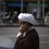 A cleric talks on his mobile phone as he arrives at a religious conference centre in Qom