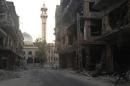 A general view shows damaged buildings along a deserted street in the Damascus suburb of Zamalka
