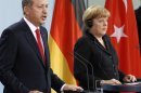German Chancellor Angela Merkel, right, and Turkey's Prime Minister Recep Tayyip Erdogan, left, address the media during a joint press conference after a meeting at the chancellery in Berlin, Germany, Wednesday, Oct. 31, 2012. (AP Photo/Michael Sohn)