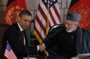 FILE - In this May 2, 2012, file photo President Barack Obama and Afghan President Hamid Karzai shake hands after making statements before signing a strategic partnership agreement at the presidential palace in Kabul, Afghanistan. Support for the war in Afghanistan has reached a new low, with only 27 percent of Americans saying they back the effort and about half of those who oppose the war saying the continued presence of American troops in Afghanistan is doing more harm than good, according to an AP-GfK poll. (AP Photo/Charles Dharapak, File)