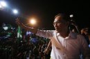 Malaysia's opposition leader Anwar Ibrahim waves to his supporters during an election campaign in Seberang Jaya