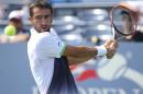 Gilles Simon, of France, returns a shot against Marin Cilic, of Croatia, during the fourth round of the 2014 U.S. Open tennis tournament, Tuesday, Sept. 2, 2014, in New York. (AP Photo/John Minchillo)