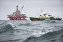 An undated handout photo shows Greenpeace ship Esperanza sailing past Transocean Spitsbergen oil rig on the Norwegian Arctic