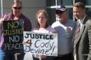 Family and friends of Cody Devine, from left Devine's longtime friend, Amanda Gavin; his mother, Debbie Peckham; uncle, Rick Winters; and the Rev. Howard Dotson, a Sparks pastor. stand in front of the Washoe County court complex Wednesday, May 28, 2014, in Reno, Nev. Wayne Burgarello, 73, was charged with murder in the fatal shooting of Devine and wounding of a female companion. Burgarello claimed he was acting in self-defense on Feb. 13 when he found the two in a vacant duplex he owned in Sparks. (AP Photo/By Scott Sonner).