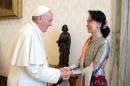 A photo taken on October 28, 2013 and released by the Osservatore Romano shows Myanmar opposition leader Aung San Suu Kyi (R) being welcomed by Pope Francis at the Vatican