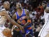 Miami Heat's Ray Allen fouls New York Knicks' J.R. Smith as the Heat's LeBron James looks on in the send half of their NBA basketball game in Miami, Florida