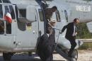 French President Francois Hollande, gets out from a Super Puma helicopter as he arrives with French officials to a ceremony to pay tribute to the French resistance during World War II, at the Mont Faron memorial in Toulon, southern France, Friday, Aug. 15, 2014. France celebrates the 70th anniversary of the Allied invasion of its southern coast, highlighting the participation of African troops to the operation, launched ten weeks after D-Day, that hastened the German defeat and the end of the World War II. (AP Photo/Michel Euler, Pool)
