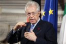 Italian PM Monti gestures next to German Chancellor Merkel during a news conference at Villa Madama in Rome