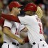 Washington Nationals third base coach Bo Porter (16) embraces third baseman Ryan Zimmerman (11) after their 4-1 win over the Los Angeles Dodgers, earning them a playoff spot, during their baseball game at Nationals Park, in Washington, Thursday, Sept. 20, 2012. (AP Photo/Jacquelyn Martin)