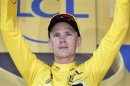 Froome celebrates on the podium of the 173 km thirteenth stage of the centenary Tour de France cycling race from Tours to Saint-Amand-Montrond