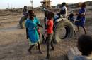 Children play at a railway station camp, where refugees from South Sudan have stayed for four years, in Khartoum
