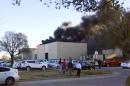 In the image from video provided by KAKE News black smoke billows from a building at Mid-Continent Airport where officials say a plane crashed Thursday, Oct. 30, 2014 in Wichita, Kan. AP Photo/KAKE News) MANDATORY CREDIT