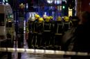 Firemen confer at the scene following an incident at the Apollo Theatre, in London's Shaftesbury Avenue, Thursday evening, Dec. 19, 2013, during a performance at the height of the Christmas season, with police saying there were "a number" of casualties. It wasn't immediately clear if the roof, ceiling or balcony had collapsed during a performance. Police said they "are aware of a number of casualties," but had no further details. (AP Photo by Joel Ryan, Invision)