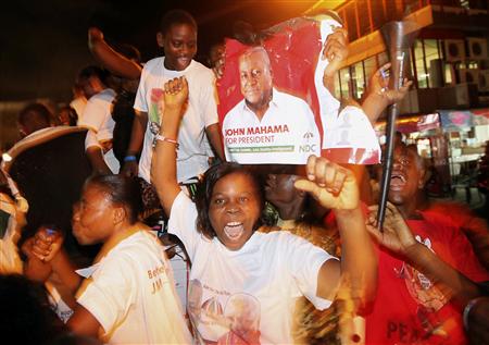 Supporters of National Democratic Congress (NDC), the party of the late Ghanaian President John Atta Mills, carry a poster of their candidate John Dramani Mahama as they celebrate his victory along a street in Accra December 9, 2012. Ghana's main opposition National Patriotic Party said on Sunday the country's presidential election had been manipulated, raising concerns about the outcome of the poll in a nation seen as a bulwark of democracy in an unstable region. REUTERS/Luc Gnago