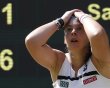 Marion Bartoli of France reacts as she defeats Sabine Lisicki of Germany in their women