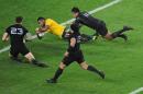Australia's Tevita Kuridrani scores a try in the tackle of New Zealand's Julian Savea and New Zealand's Sonny Bill Williams during their Rugby World Cup final match between New Zealand and Australia at Twickenham Stadium, London, Saturday, Oct. 31, 2015. (AP Photo/Rob Taggart)