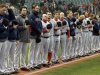 The Boston Red Sox players and coaches observe a moment of silence for the victims of the Boston bombings before a baseball game  against the Cleveland Indians Tuesday, April 16, 2013, in Cleveland. (AP Photo/Mark Duncan)