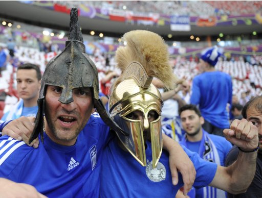 Fans of Greece cheer before the start of their Group A Euro 2012 soccer match against Poland at the National stadium in Warsaw