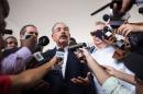 Dominican President Danilo Medina (C), speaks to the press after voting at a polling station in Santo Domingo during the general election on May 15, 2016