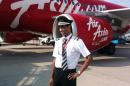 This picture taken in 2013 and provided on December 31, 2014 by the Plesel family shows Remi Emmanuel Plesel of the French island and overseas department of Martinique, posing in front of an Air Asia aircraft at an unknown location