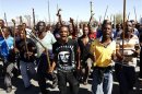 Mine workers take part in a march at Lonmin's Marikana mine in South Africa's North West Province