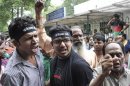 Demonstrators shout slogans outside a juvenile court in New Delhi