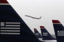 An American Eagle jet takes off as U.S. Airways jets are lined up at Reagan National Airport in Washington