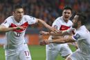 Turkey's Volkan Sen, right, and Turkey's Ozan Tufan, center, run towards Turkey's Burak Yilmaz, left, who scored his side's first goal during the Euro 2016 group A qualifying soccer match between the Netherlands and Turkey at Arena stadium in Amsterdam, Netherlands, Saturday, March 28, 2015. (AP Photo/Peter Dejong)