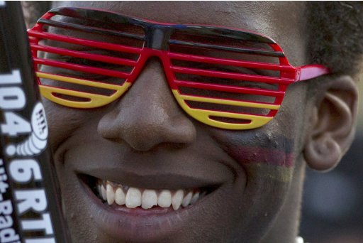 A Germany supporter wears glasses in the colours of the Germany national flag during public screening of Euro 2012 soccer match at in Berlin
